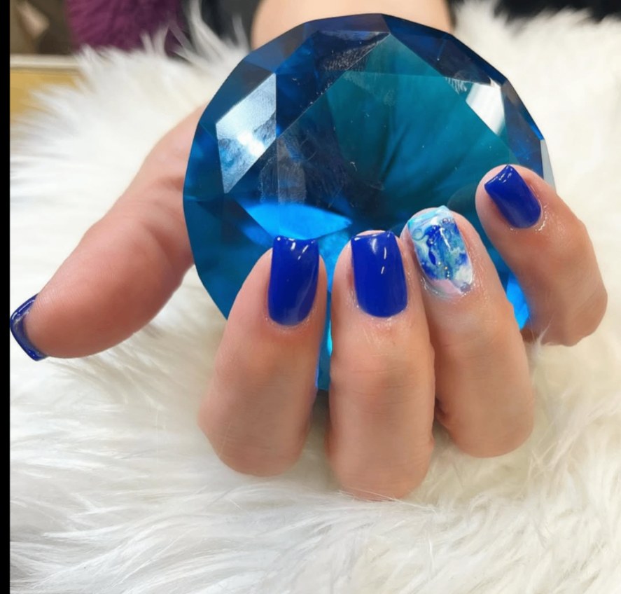 Cobalt blue nails with a marbled accent nail