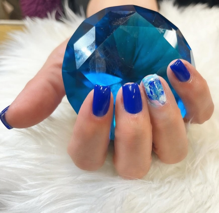Cobalt blue nails with a marbled accent nail